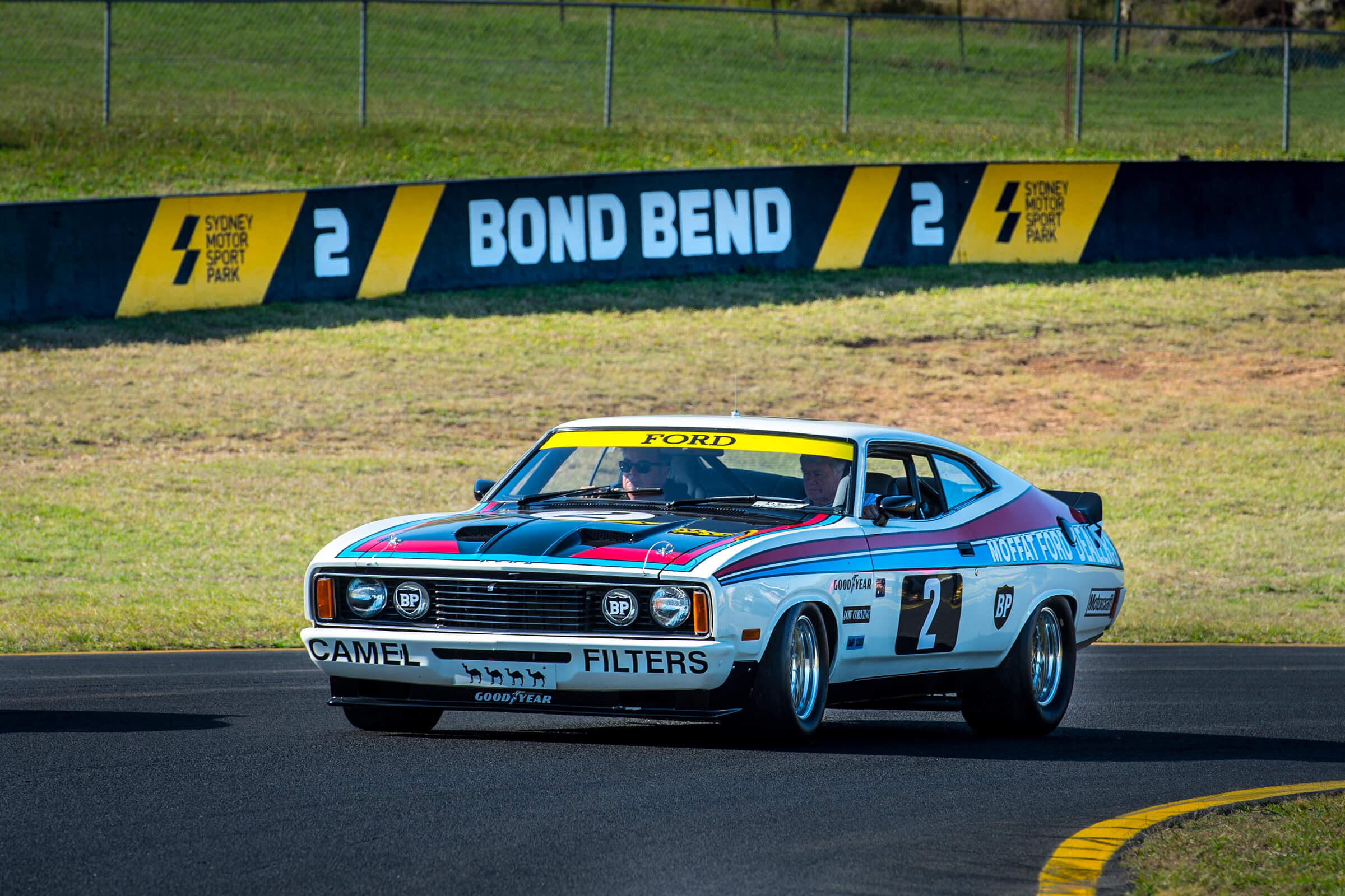 A classic Moffat Ford Falcon V8 race car at Bond Bend