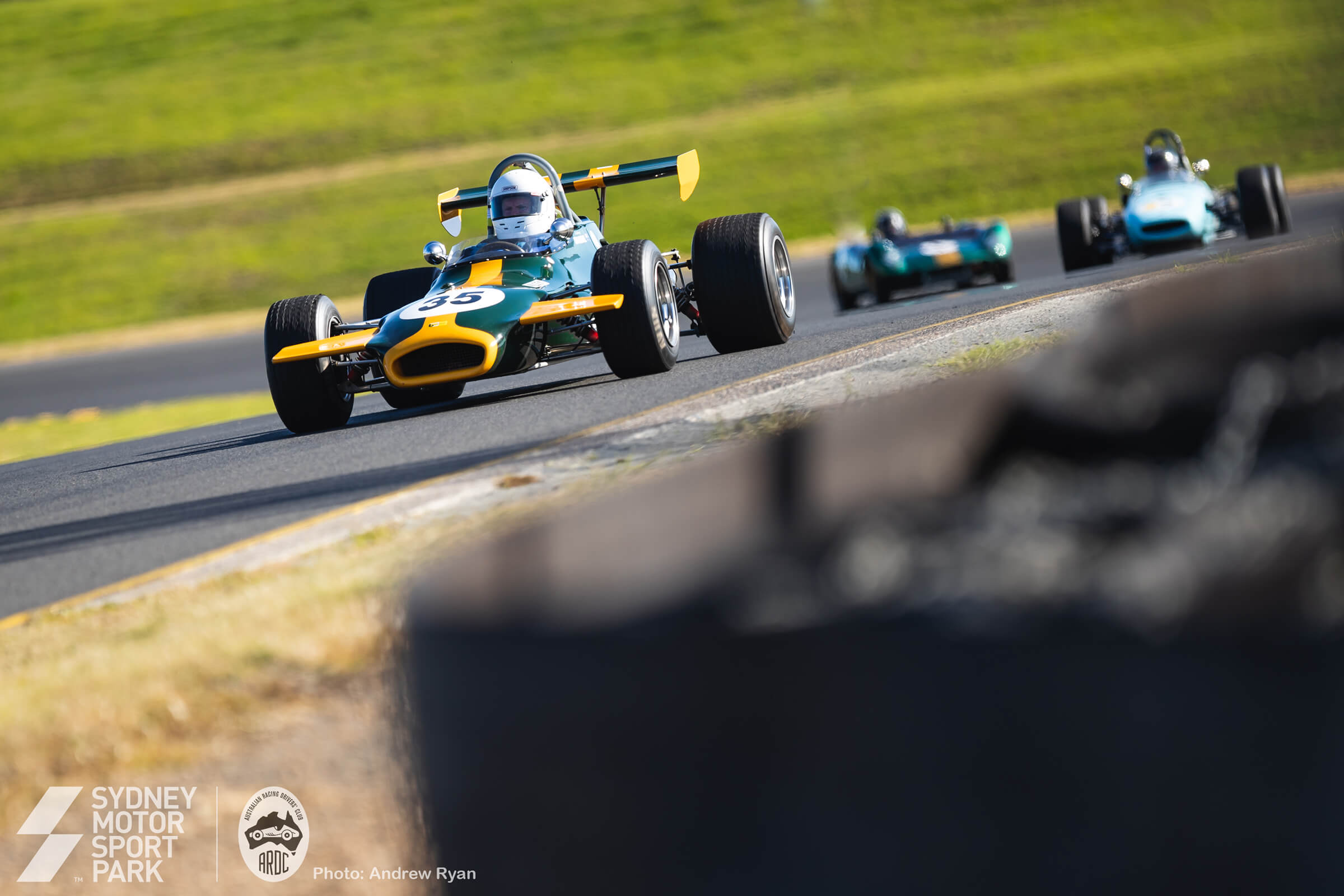 Open-wheel single-seaters at speed on the Gardner GP circuit.
